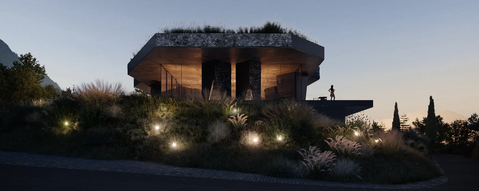 The hotel from the gardens at dusk, the interiors lit behind glass.