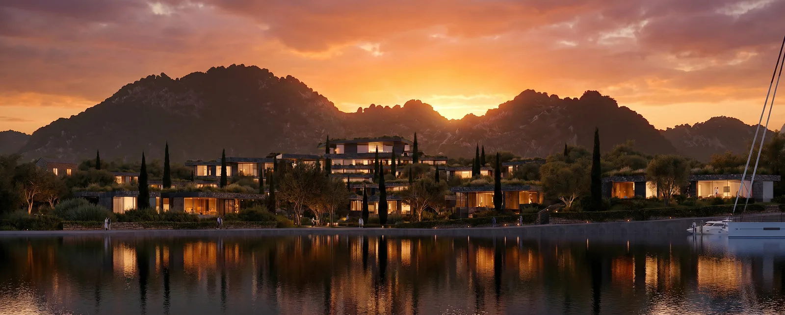 Still water reflecting the building at dusk, with cypresses and the mountains beyond.