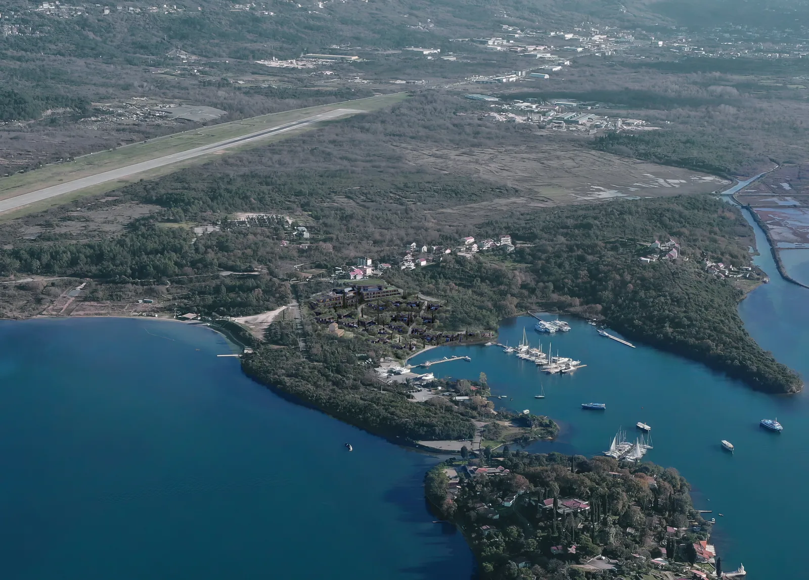 Aerial photograph with the airport runway above and the bay below.
