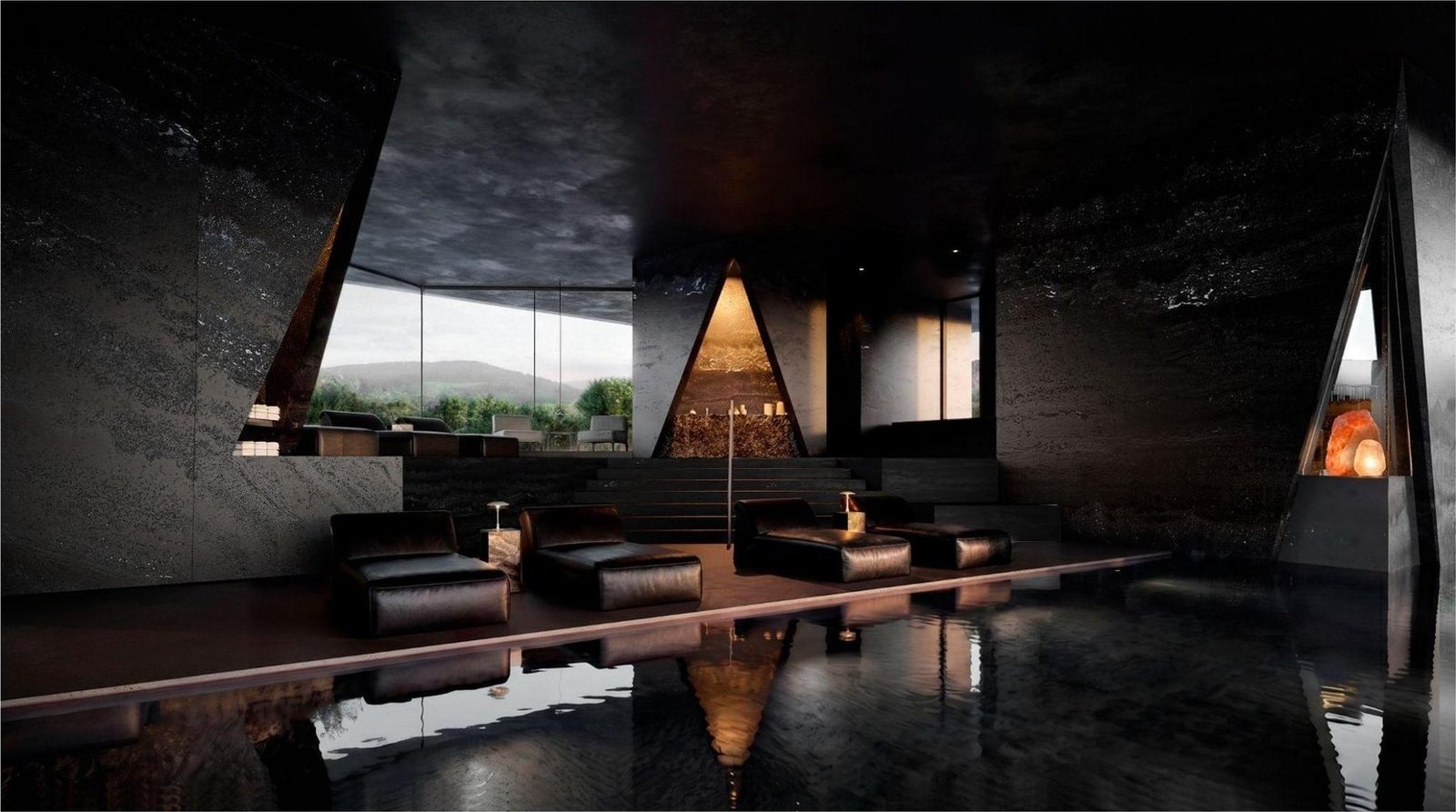 Indoor pool in dark stone lit from a slot of daylight