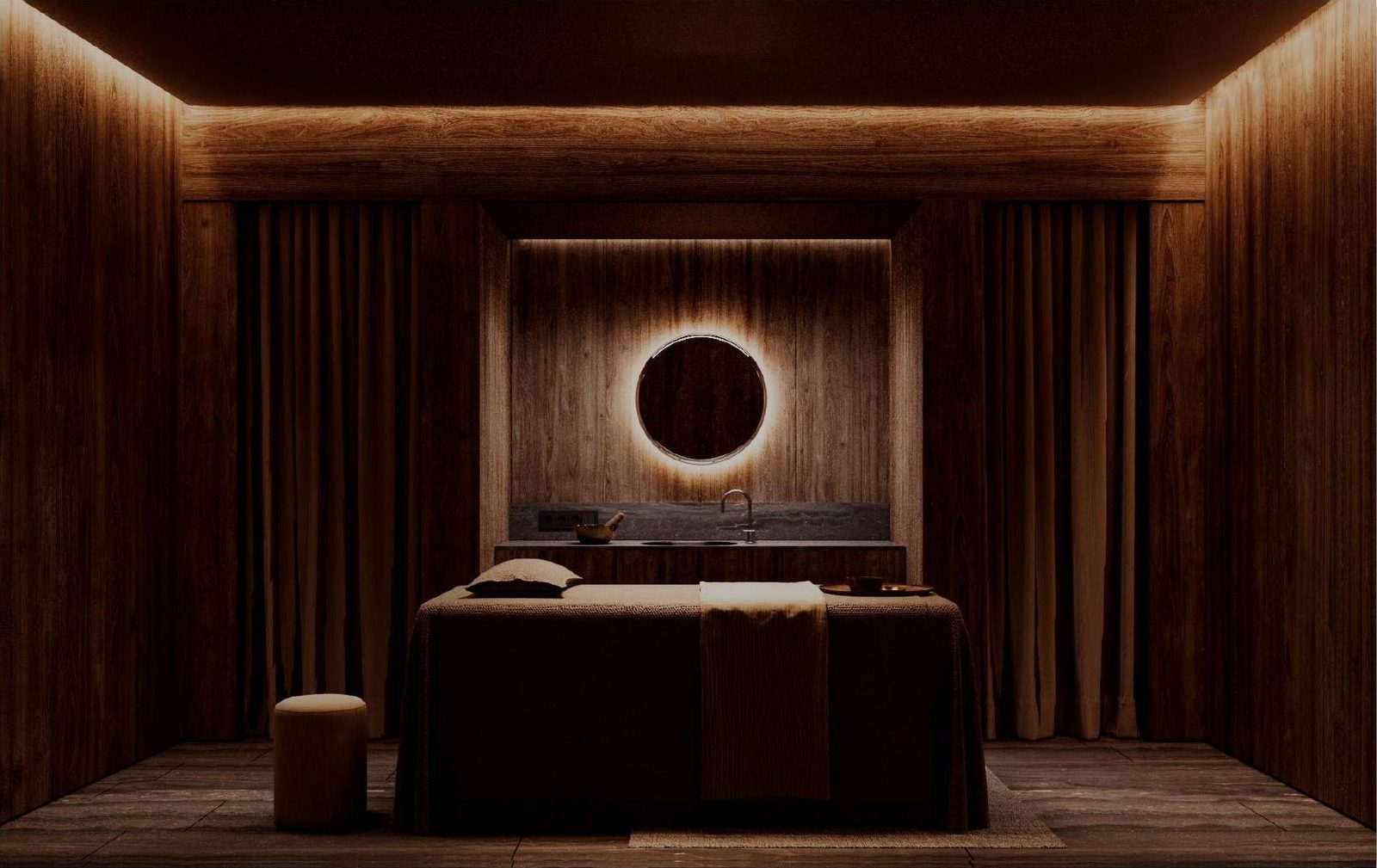 Treatment room lined in warm wood slats with a circular mirror